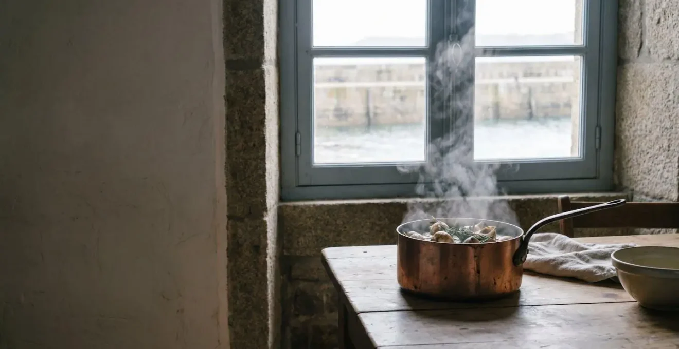 Casserole en cuivre de bulots fraîchement pêchés cuisant dans un court-bouillon iodé, dans une cuisine côtière bretonne